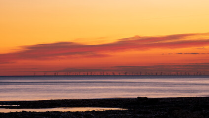 Obraz premium Dusk light from Hope Gap Seaford Head with Rampion offshore wind farm on the horizon off the east Sussex coast south east England