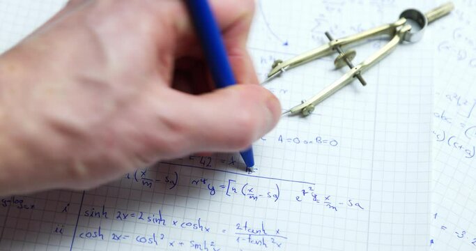 Man writing math exercise in notebook closeup