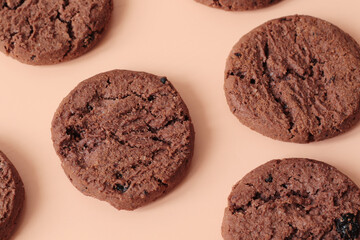 sweet brown chocolate chip cookies on peach pink background