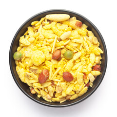 Ceramic bowl, made with peanuts, sugar, raisins, and besan sev. Pile of Indian spicy snacks (Namkeen), Top view