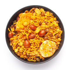 Close-Up of Hot spicy Nav Ratan snacks in a black Ceramic bowl, made with red chili, peanuts. Indian spicy snacks (Namkeen), Top View                                                                  