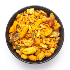 Close-Up of Indian spicy snacks (Namkeen) - (All in one) in a black Ceramic bowl, made with fried peanut, corn flakes, sweet pea, pulses, cashew nuts. Top View