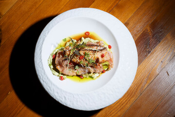salmon cooked in a restaurant, a dish in a restaurant, a beautiful serving of a dish, fish in a hot sauce