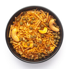 Close-Up of Hot spicy Kashmiri Mixture (Namkeen) snacks in a black ceramic bowl made with dry fruits, peanuts,.  Indian spicy snacks, Top View