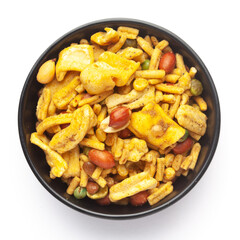 Close up of plane salty Golden Mixture Indian namkeen (snacks) on a ceramic black bowl. Top view