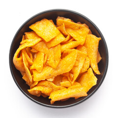 Close up of Soya Chips crunchy and salty Indian Namkeen on a ceramic white bowl. Top view