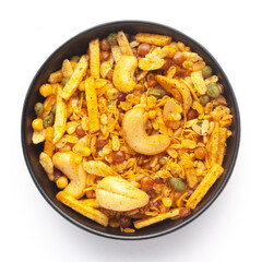Close up of Rich Spicy Kaju Mixture  Indian namkeen (snacks) on a ceramic black bowl. Top view