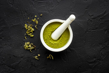 Henna powder in white mortar. Herbal natural hair dye