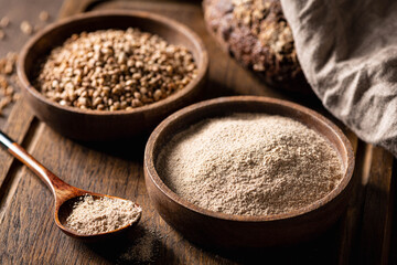 buckwheat and buckwheat flour on a wooden kitchen board, gluten-free. - obrazy, fototapety, plakaty