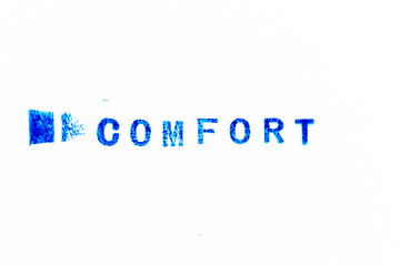 Blue color ink of rubber stamp in word comfort on white paper background