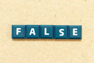 Tile alphabet letter in word false on wood background