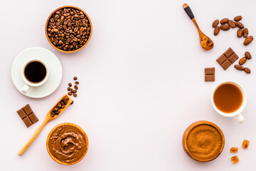 Frame of assorted coffee and cocoa - beans with powder and hot drink. Overhead view