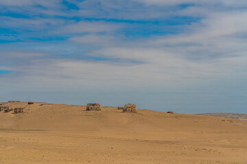 Fototapeta na wymiar Distance landscape over German Kolmanskop Ghost Town with the abandoned buildings in the Namib desert