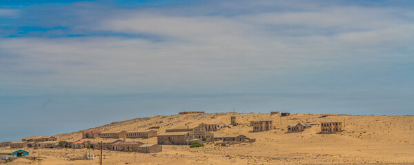 Distance landscape over German Kolmanskop Ghost Town with the abandoned buildings in the Namib desert