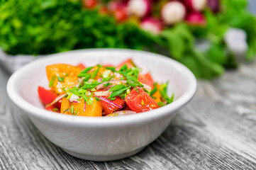 Fresh rustic vegetable salad on rustic background