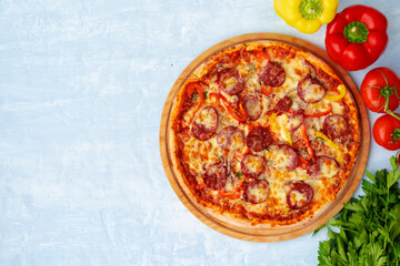Delicious pizza with sausages on gray background