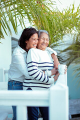 Beautiful senior filipino woman sharing some family time with her daughter - 422766207