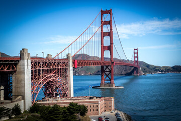 Daytime shot of Golden Gate Bridge under a bright blue sky