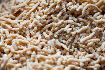 Close up of grind poultry meat. Photo taken under natural light shining through the window. Plastic...