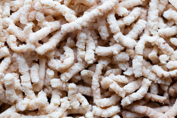 Close up of grind poultry meat. Photo taken under natural light shining through the window. Plastic...