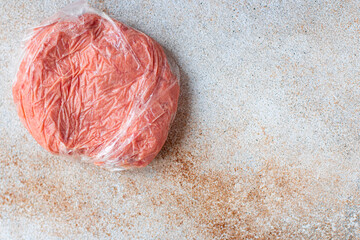 frozen minced meat portion in a plastic bag long-term storage of food portion on the table healthy...
