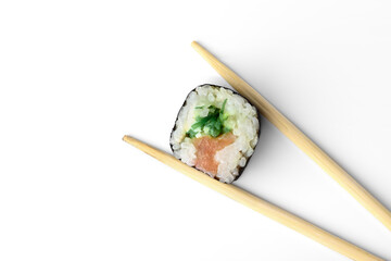 Sishi roll with salmon in chopsticks isolated on white background.