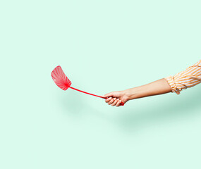 Red fly swatter on a teal background