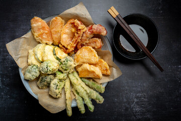 Flat lay of Japanese vegetable tempura recipe with ginger ponzu sauce , black background with copy...