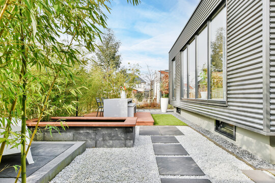 Beautiful Backyard Terrace Full Of Furniture And Decorative Plants