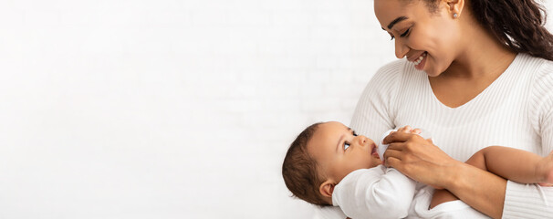 African Mother Feeding Baby Standing On White Background, Panorama, Cropped