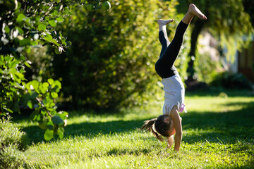 Girl doing cartwheel in backyard