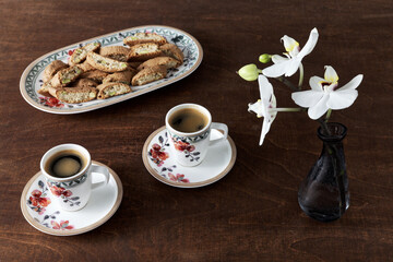 Espresso coffee and cantuccini biscuits with pistachio nuts. Sweet Italian breakfast.