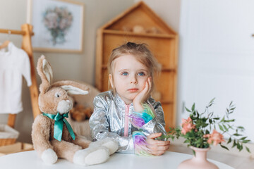 Adorable cute joyful caucasian girl plays with toys at home. Childhood, home leisure concept