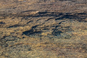 stone ground under shallow and calm sea water surface