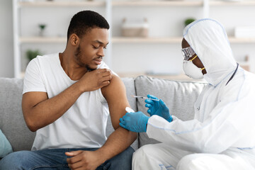 Black man receiving COVID-19 vaccine shot at home