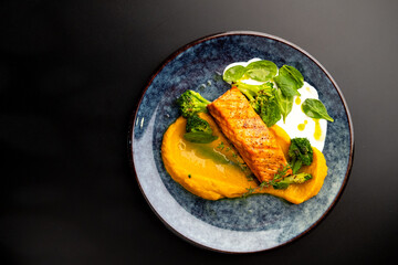 Grilled red fish fillets. Salmon with vegetable puree and spinach.