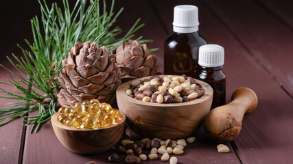 natural product cedar nut oil with glass bottles and cones on a wooden table