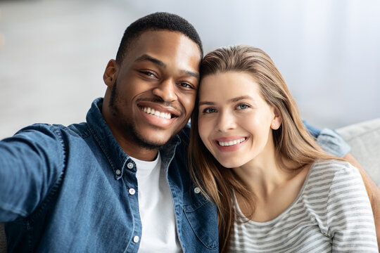 Happy Interracial Couple Taking Selfie Together At Home