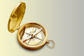 Old style brass compass on white background