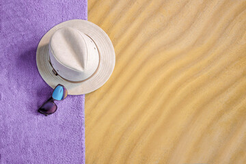 Concept of summer holidays with straw hat and sunglasses on sandy beach