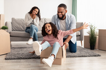 Happy black family celebrating moving day in new flat