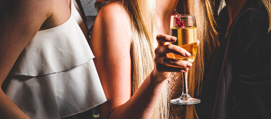 glass of champagne in woman hand at a party