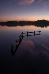 Sunset view of wooden boat dock in in lake in Groningen, the Netherlands