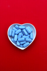 Blue pills on red background.
