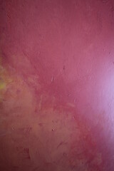 Fototapeta premium A painted plaster wall in varying shades of pink , an abstract background