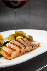 Grilled salmon fillet with vegetables mix. dark background