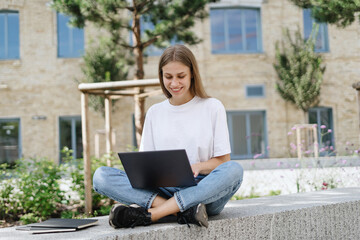 Adult student girl using modern laptop computer