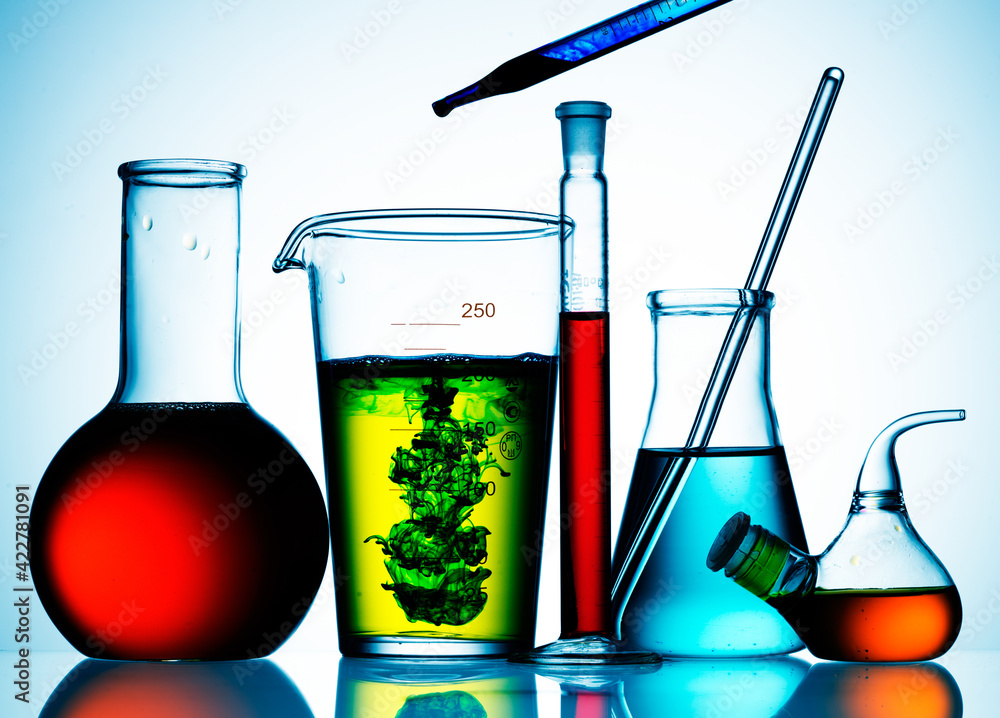 Wall mural different laboratory glassware with color liquid and with reflection
