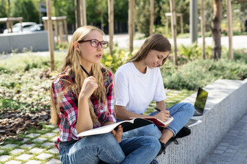 Two adult academy student girl spending time near campus