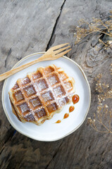 Fresh homemade waffles  for breakfast on wooden background.
